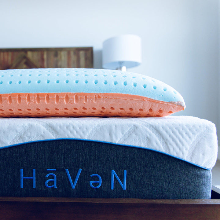 Sideview of Bedface VitaGel 4-in-1 Pillow on top of a Haven Mattress with Embroidered logo