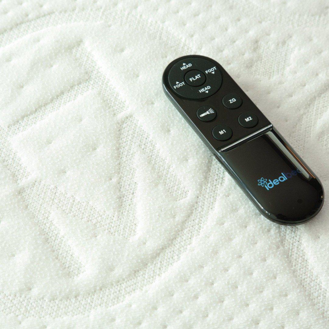 10 SPLIT KING_202105_split king_rejuvenate_adjustable_powerframe_bedframe_grey_middle age_ bri steve_side sleeper_side sleeper pillow_white sheets_white bedding_reading_working_book_ipad_couple