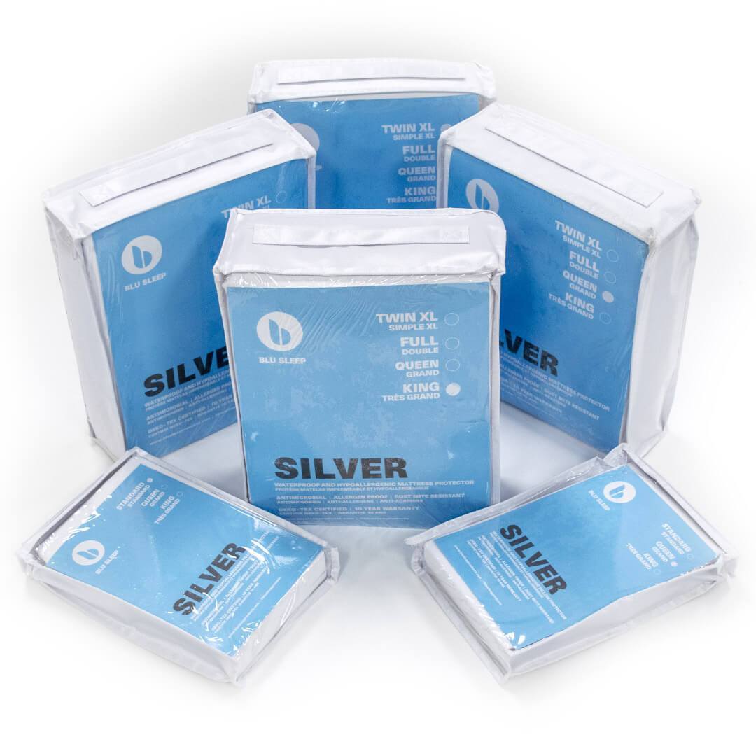 four SILVER Bedface mattress protectors including two SILVER pillow protectors in plastic and blue zip up packaging with handles that say 'Blu Sleep' with logo in various bed sizes to be used on twin, queen, or king mattresses