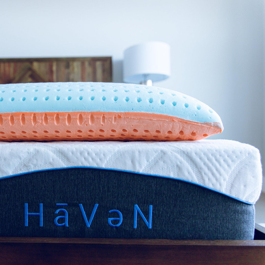 Sideview of Bedface VitaGel 4-in-1 Pillow on top of a Haven Mattress with Embroidered logo